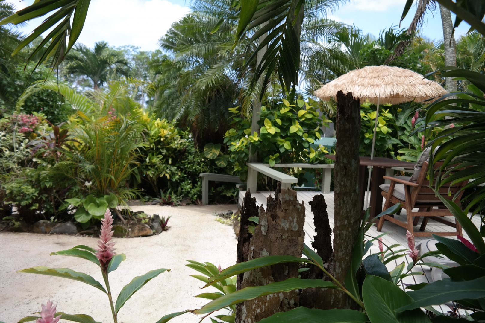 Outdoor seating among the tropical gardens at Muri Retreat